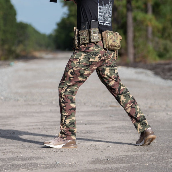 Savage Tacticians camo tactical pants and gear pouch worn outdoors