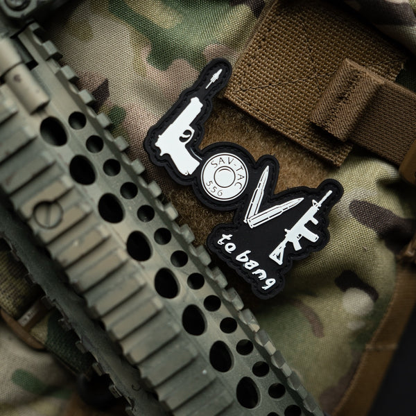 Savage Tacticians 'Love to Bang' morale patch on tactical gear and camouflage fabric