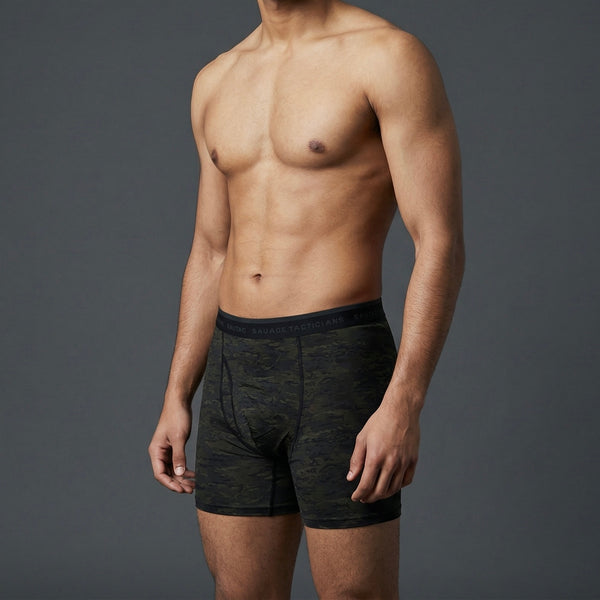Male model in camo boxer briefs with Savage Tacticians logo waistband, gray background