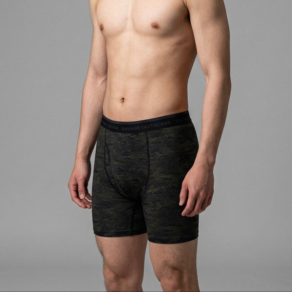 Male model wearing Savage Tacticians black camo boxer briefs on gray background