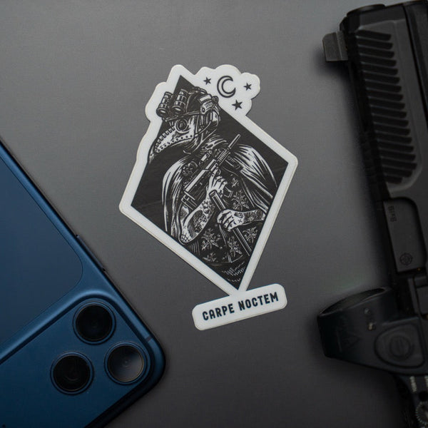 Savage Tacticians Carpe Noctem sticker with tactical figure, gun, and smartphone on gray surface