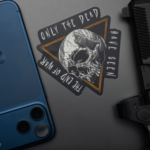Savage Tacticians skull sticker with 'Only the Dead Have Seen the End of War' text on laptop
