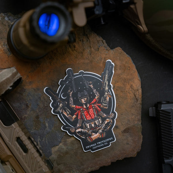 Savage Tacticians sticker of multi-armed soldier holding guns, placed on rock with tactical gear