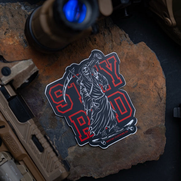 Savage Tacticians STAY RAD sticker with grim reaper on skateboard, tactical gear background