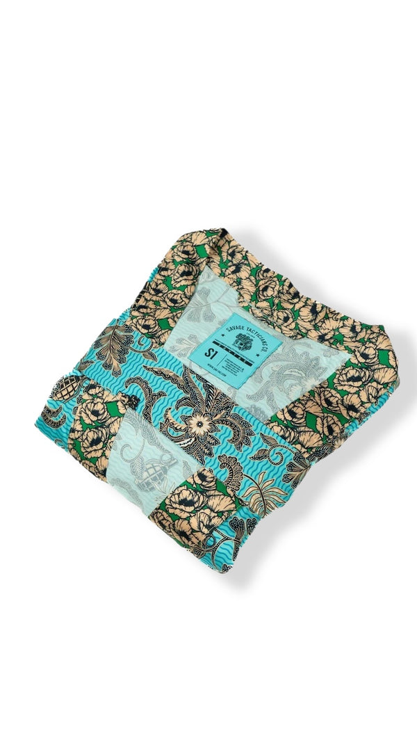 Savage Tacticians floral patterned blue and tan button-up shirt, folded, with brand tag visible