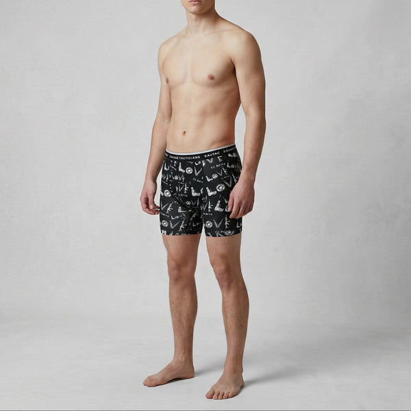 Male model wearing Savage Tacticians black graphic boxer briefs, brand logo on waistband.