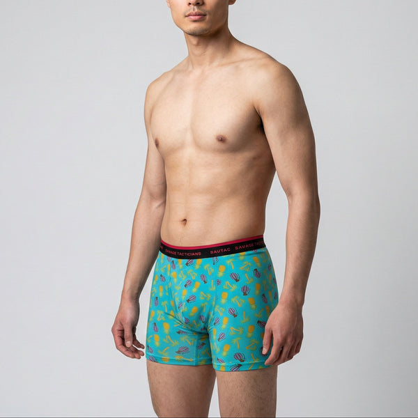 Man wearing Savage Tacticians aqua boxer briefs with colorful tropical print