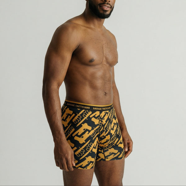 Male model wearing Savage Tacticians graphic boxer briefs with yellow and black pattern