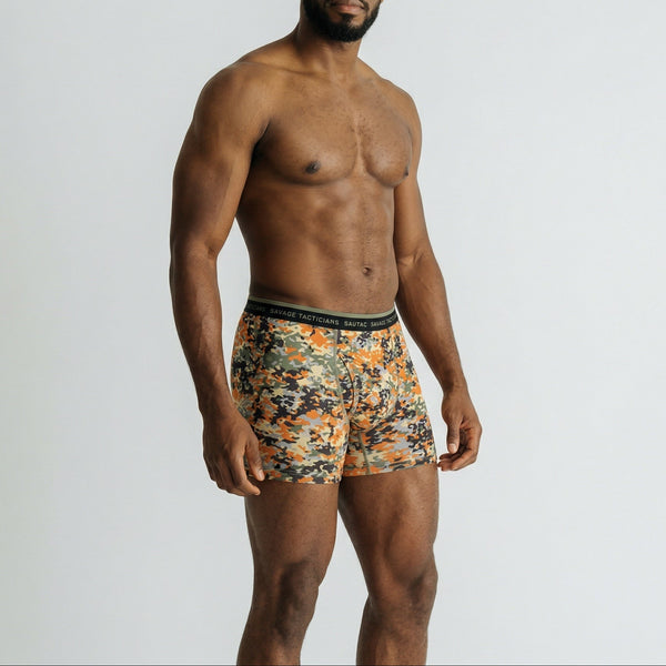 Man modeling Savage Tacticians camo boxer briefs with branded waistband on white background