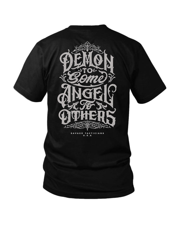 Savage Tacticians Black tee featuring ornate gothic lettering reading "Demon To Some Angel To Others, Savage Tacticians U.S.A."