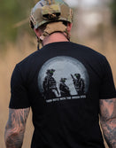 Man in tactical helmet wearing Savage Tacticians shirt with night vision green eyes graphic