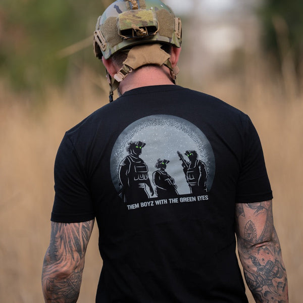 Man in tactical helmet wearing Savage Tacticians shirt with night vision green eyes graphic