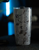 Savage Tacticians camo stainless steel tumbler with lid on dark surface