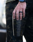 Savage Tacticians camo tumbler held by person in camouflage pants outdoors