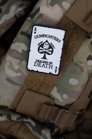 Camouflage tactical vest with Savage Tacticians Gunfighters Ace morale patch attached