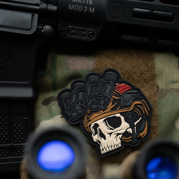 Savage Tacticians tactical skull patch with helmet and night vision on camouflage background