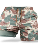 Savage Tacticians camo shorts with palm tree and helicopter print, elastic waistband