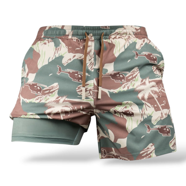 Savage Tacticians camo shorts with palm tree and helicopter print, elastic waistband