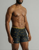 Male model wearing Savage Tacticians black boxer briefs with bullet pattern