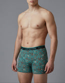 Male model in teal patterned Savage Tacticians boxer briefs, logo on waistband
