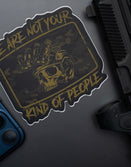 Savage Tacticians skull sticker with night vision and 'We are not your kind of people' text on laptop