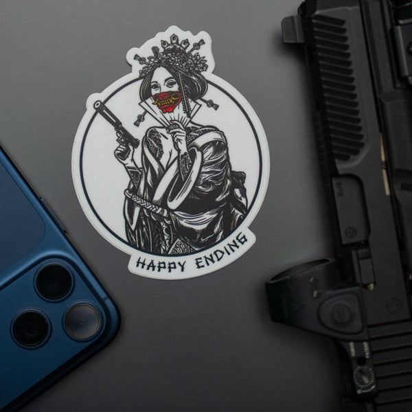 Savage Tacticians Happy Ending sticker with geisha, gun, and fan on gray background near a phone and firearm
