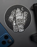 Savage Tacticians sticker featuring praying hands holding binoculars, beside a blue phone and handgun