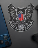 Savage Tacticians eagle sticker with US flag shield and 'Forged Through Adversity' text