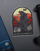 Savage Tacticians sticker of a modern samurai with gear, sunset background, phone and pistol nearby