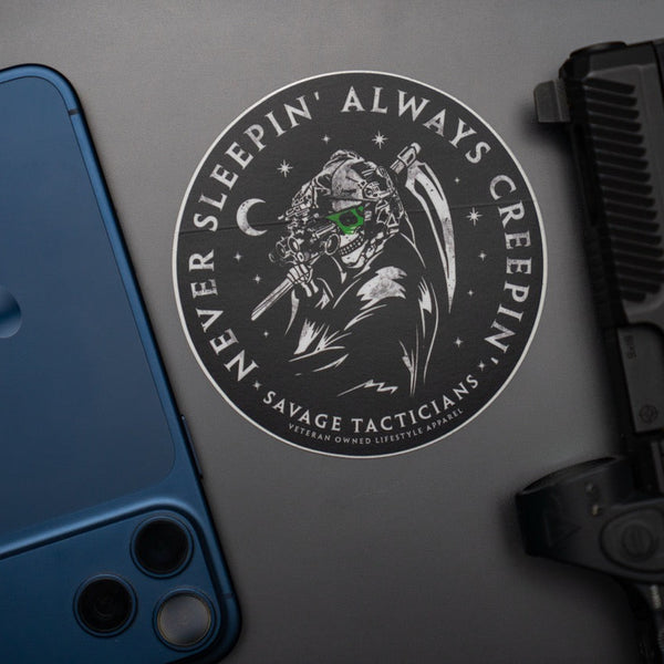 Savage Tacticians sticker featuring tactical grim reaper with night vision, next to phone and handgun.