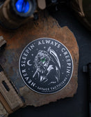 Savage Tacticians sticker featuring a skull with night vision goggles and tactical gear, on a rock