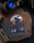 Savage Tacticians sticker featuring a samurai with helicopter, sunset, mountains, and gear