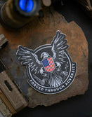 Savage Tacticians eagle sticker with American flag shield and 'Forged Through Adversity' text