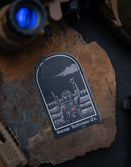 Savage Tacticians patch with soldier graphic on a rock, tactical gear nearby