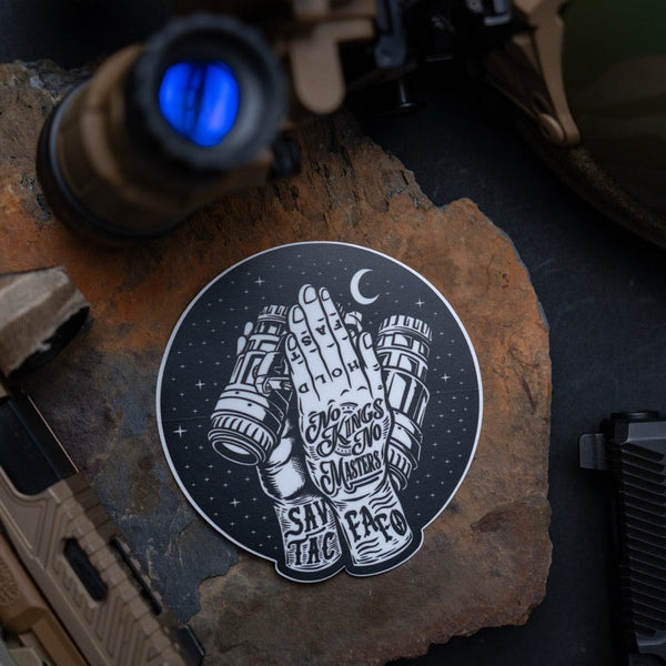 Savage Tacticians sticker with praying hands, night vision goggles, tactical gear background