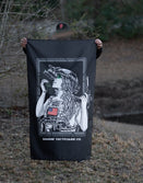 Person outdoors holding Savage Tacticians flag featuring tactical woman graphic with night vision