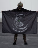 Person in tactical helmet holding Savage Tacticians flag with skull moon and 'The Goons Come Out At Night' text