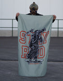 Person with tactical helmet holds Savage Tacticians Stay Rad flag featuring Grim Reaper graphic.