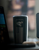 Savage Tacticians black tumbler with American flag and tactical helmet design on desk