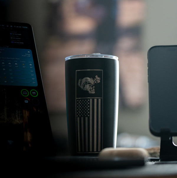 Savage Tacticians black tumbler with American flag and tactical helmet design on desk