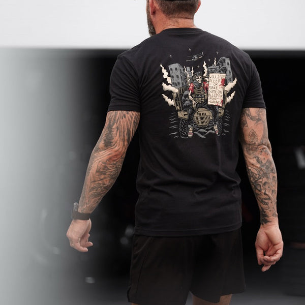Man wearing Savage Tacticians black graphic t-shirt with military-themed back print