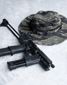 Savage Tacticians camo boonie hat with SAVTAC patch and tactical rifle on concrete