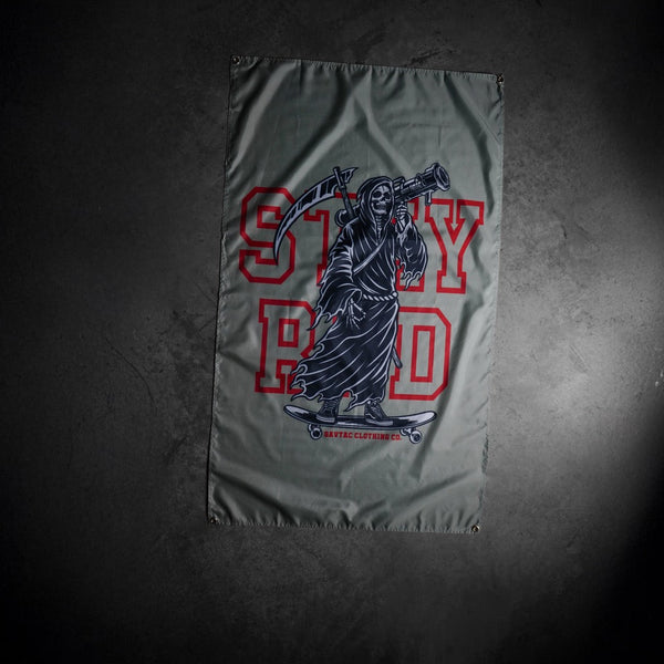 Savage Tacticians flag featuring a grim reaper on skateboard holding a launcher, with 'STAY RAD' text.