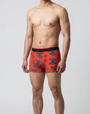 Man wearing Savage Tacticians orange floral boxer briefs with logo waistband