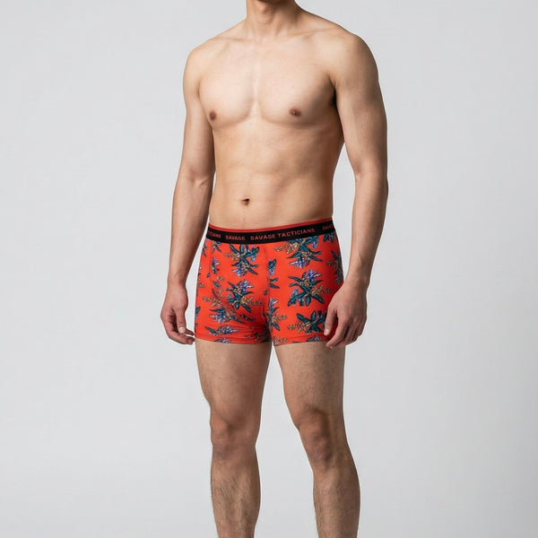 Man wearing Savage Tacticians orange floral boxer briefs with logo waistband