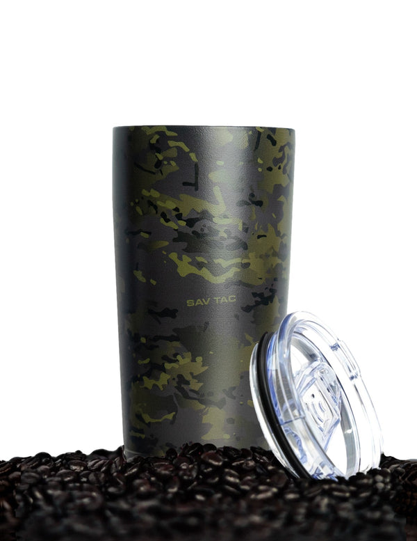 Savage Tacticians black camo tumbler with clear lid on coffee beans