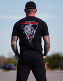 Model wearing the Saboteur graphic tee in a urban setting.