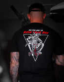 Model wearing the Savage Tacticians Saboteur tee while holding a rifle.