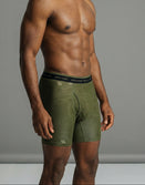 Man modeling olive green Savage Tacticians boxer briefs with topographic pattern