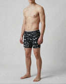 Male model wearing Savage Tacticians black graphic boxer briefs, brand logo on waistband.